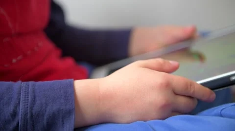 Hand held footage of a child using a computer tablet Stock Footage 64486714