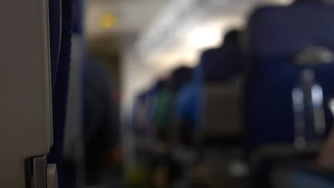 Hand-held of interior seating of airplane in flight. Video stock 107228589