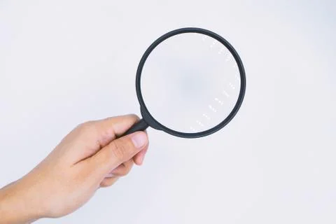 Hand-held magnifier on a white background. Stock Photos