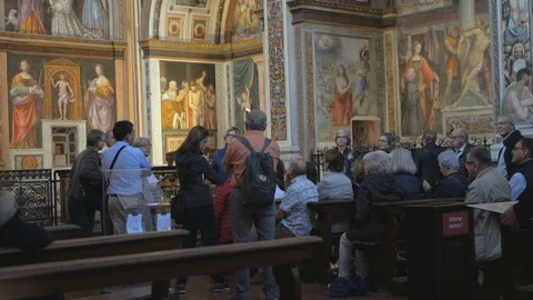 Hand held medium shot of tourists inside the Santa Maria at San Satiro church Stock Footage 119422118
