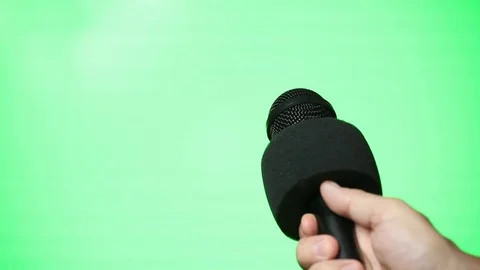 Hand held Microphone on Green Screen Stock Footage 80990513