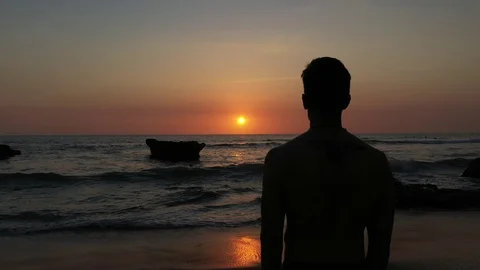 Hand Held Over The Shoulder Of Man Watching Sunset Over The Ocean 2 Stock Footage 120131527