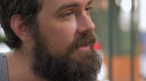 Hand held portrait of a bearded man having an intense conversation Stock Footage 57095063