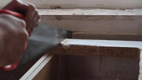 Hand Held Saw being used by a man to dismantle a Kitchen Stock-Footage 334874137