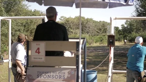 Hand Held Shot of Skeet Shoot Umpire Watching Two Shooters Stock Footage 76011376
