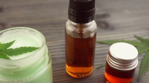 Hand held shot of various Cannabis products on wooden table Stock Footage 117377625