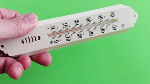 Hand-Held Thermometer: Precision in Green Hues 스톡 동영상 308300741