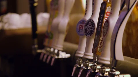 Hand held video of colored beer taps Stockbeeldmateriaal 127601006
