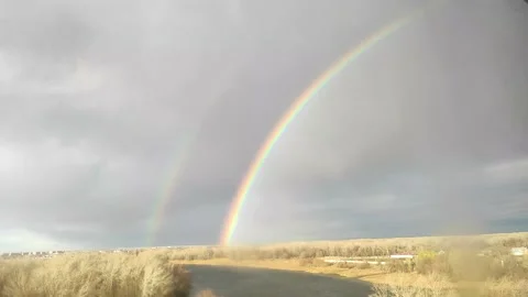 Hand held video of the rainbow in the sky Stock Footage 221837376