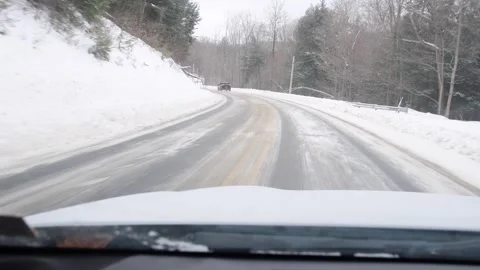 Hand held video shaky cam of a drive in maountain road covered in snow Stock Footage 262379156