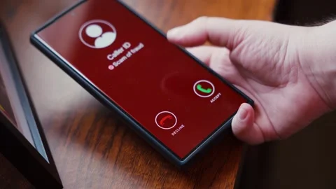 Hand hesitating to answer scam call alert on smartphone screen closeup. Stock Footage 344677883