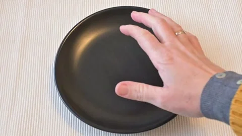 Hand Hesitating Near Empty Black Plate, Food Scarcity Decision Concept Stock Footage 337014564