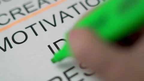 The Hand Highlights the Large Printed Word "IDEA" with an Green Marker, Close-up Stock Footage 139741776