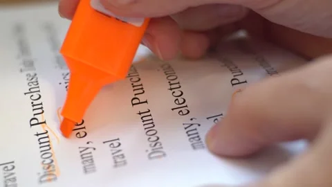 Hand highlights the word electronics on paper Stock Footage 139689637