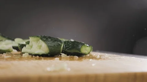 Hand hits a cucumber with a large knife Stock Footage 117779014