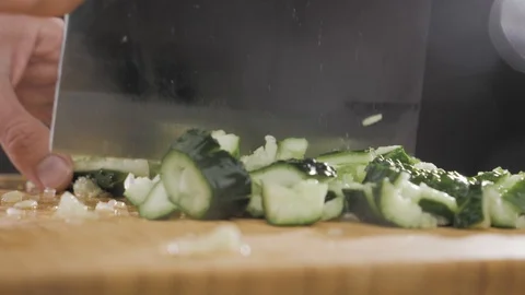 Hand hits a cucumber with a large knife Video stock 117779053