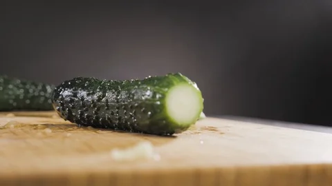 Hand hits a cucumber with a large knife Stock Footage 117779313