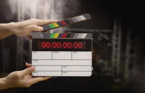 Hand hitting timecode clapperboard or movie slate for Video Production. Stock Photos