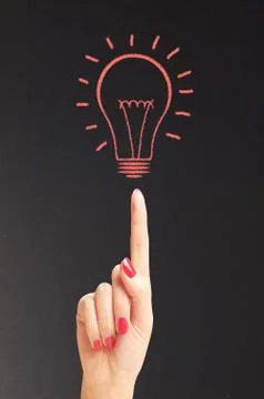 Hand hold bright light bulb with chalk board Photos
