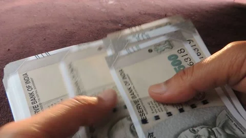 Hand hold calculate count indian 500 five hundred rupee money banknote currency Stock Footage 138799805