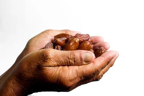 Hand hold date fruit on white background with random dates Stock Photos