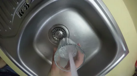 Hand hold glass filled with drinking water from kitchen tap. 4K Stock Footage 51214181