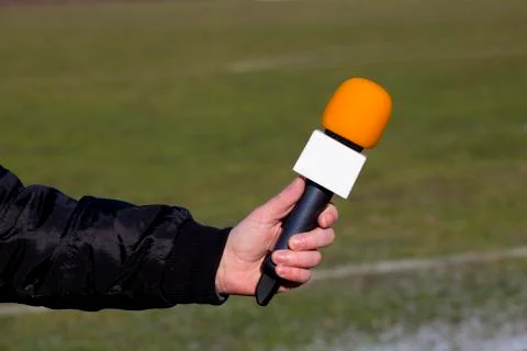 Hand hold microphone for interview during a football mach Stock Photos