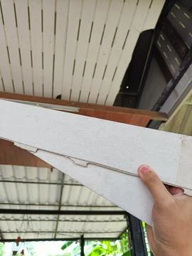 Hand hold old ceiling is damaged and needs to be repaired. Stock Photos