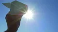 The hand hold paper airplane and launch by the bright sun background 4k or 4k+ Resolution