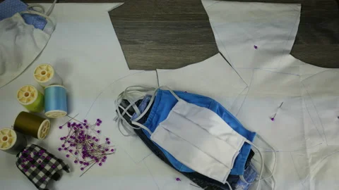 Hand hold scissors cut white cloth pattern, prepare to sew protective mask ,  Stock Footage 131340212