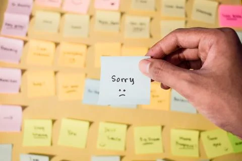 Hand hold sticky notes with words sorry, Motivational word for personal Stock Photos