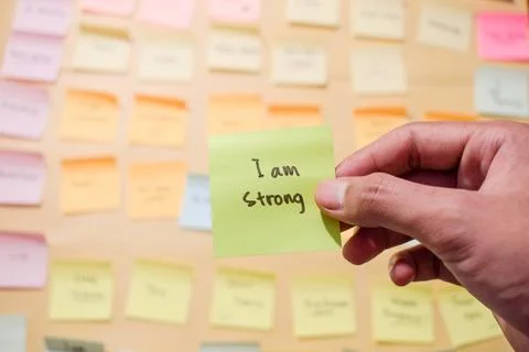 Hand hold sticky notes with words I am strong, Motivational for personal Stock Photos