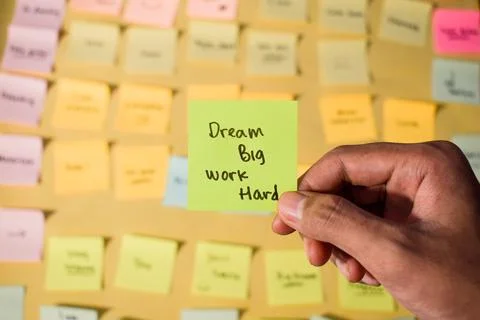 Hand hold sticky notes with words Dream Big, Work Hard. Motivational words for Foto stock