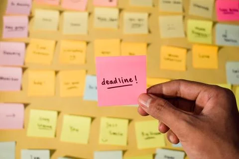 Hand hold sticky notes with words Deadline. Motivational words for personal Stock Photos