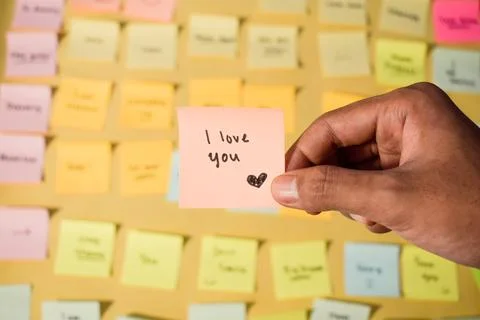 Hand hold sticky notes with words I love you. Motivational words for personal Stock Photos