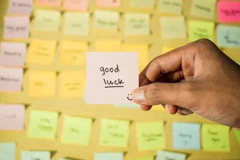 Hand hold sticky notes with words Good Luck. Motivational words for personal Stock Photos