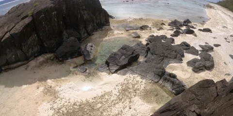 Hand hold still view of beach side coastline bay with large and small Basalt bla Stock-Footage 235311806