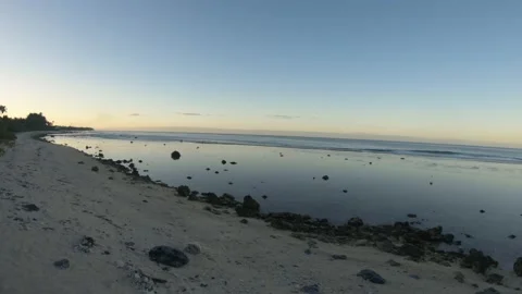 Hand hold still view of ocean coastline bay sandy rocky beach with coconut trees Stock Footage 235322955