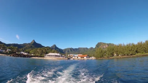 Hand hold still view riding on boat look out to Avarua township with building su Stock Footage 259463920