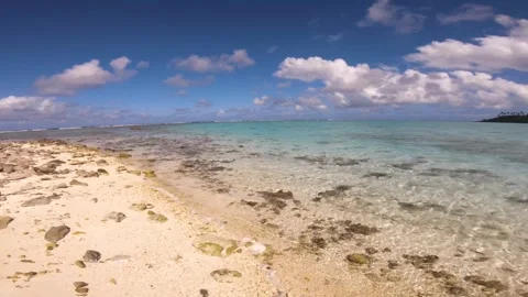 Hand hold still view sandy rocky beach view of beautiful scene of Koromiri  isle Stock Footage 250401335
