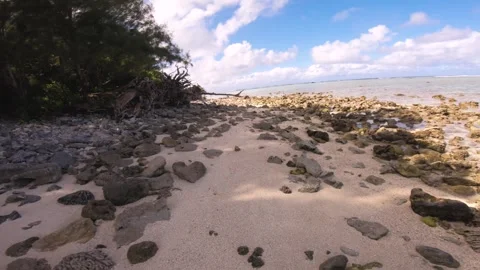 Hand hold still view sandy rocky beach in shadow view of Koromiri islet look out Video stock 250401468