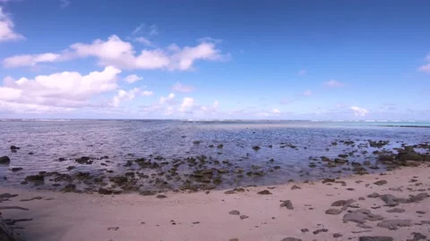 Hand hold still view sandy super rocky coral beach view of Koromiri islet look o Stock Footage 250401516