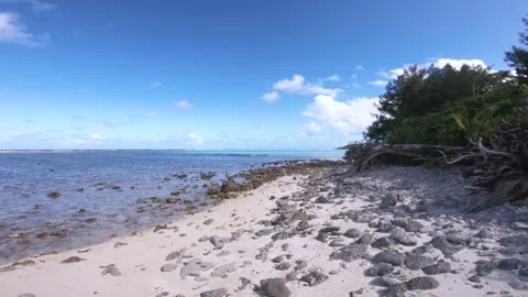 Hand hold still view sandy rocky beach in shadow view of Koromiri islet look out Stock Footage 250401677