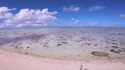 Hand hold still view sandy rocky coral beach of Koromiri islet look out to pacif Stock Footage 250401857