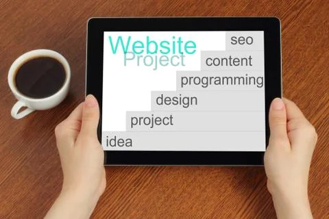 Hand hold tablet pc with website project's development steps. Stock Photos