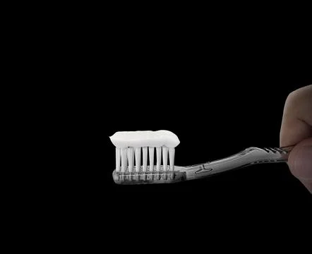 Hand hold toothbrush on black background. dental care symbol concept Stock Illustration