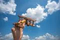The hand hold a toy plane on the background of the cloud Photo