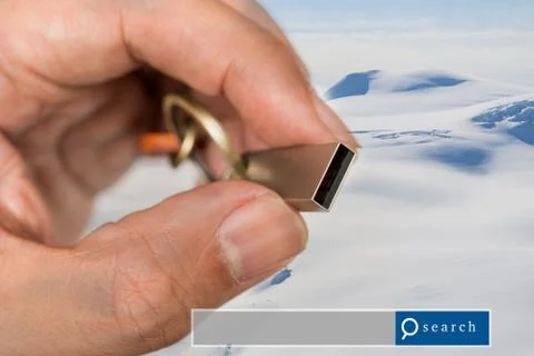 Hand hold USB Flash Drive double exposure with snow mountain with search en.. Stock Photos