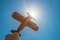 The hand hold a wood plane on the background of the sun Photo