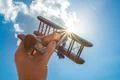 The hand hold a wood plane on the background of the cloud Photo